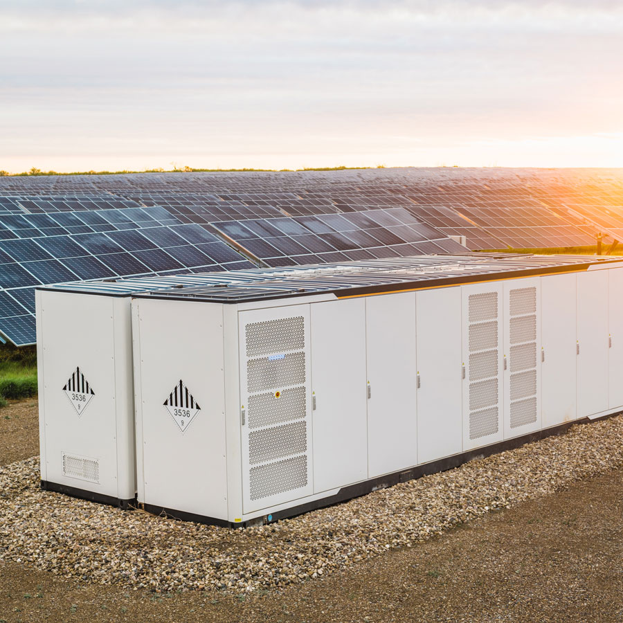 battery-storage Solar panels and electrical boxes in a large field
