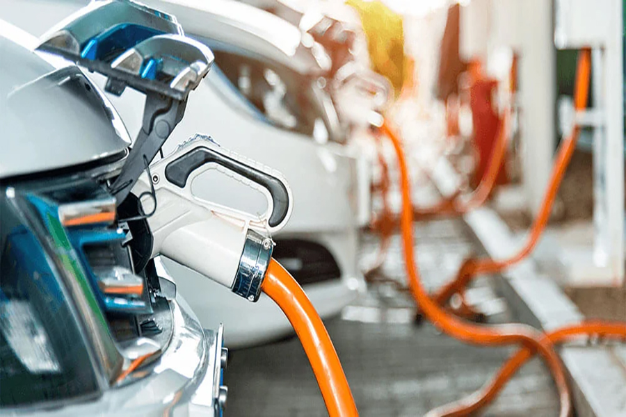 Vehicles are lined up at EV charging stations
