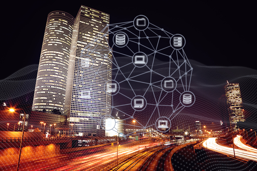 City skyline at night with internet communications icons connected around it