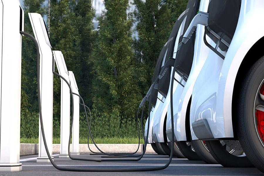 Vehicles are lined up at EV charging stations