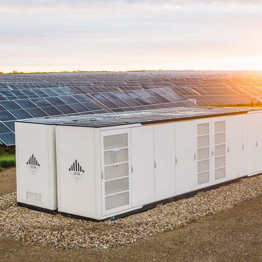 Solar panels and electrical boxes in a large field